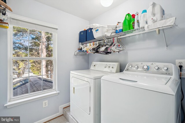 washroom featuring washer and dryer, laundry area, and baseboards