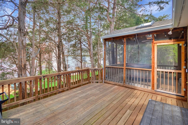 wooden terrace featuring a sunroom