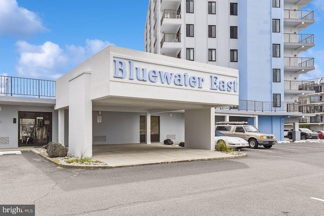 view of building exterior with uncovered parking
