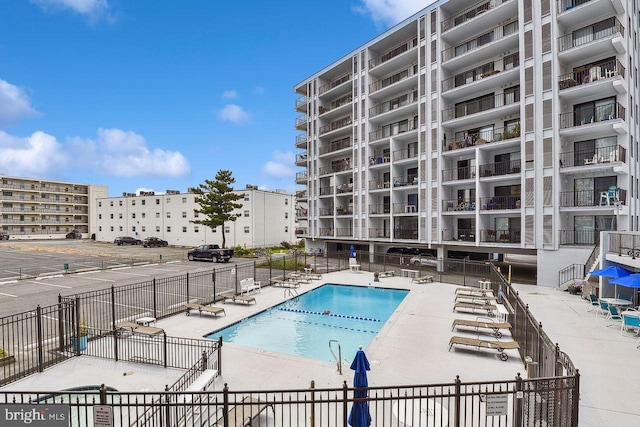 pool featuring a patio area and fence