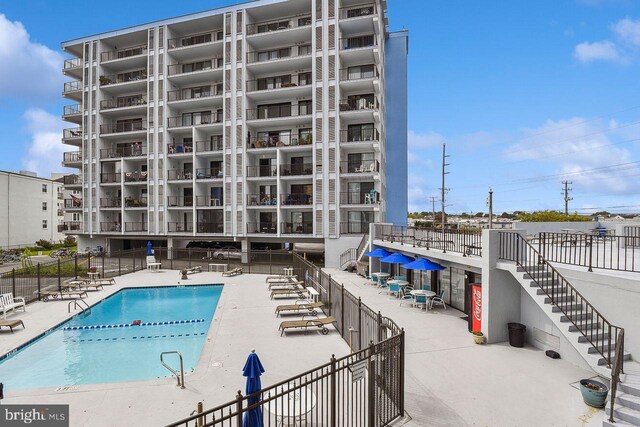 pool featuring a patio area and fence