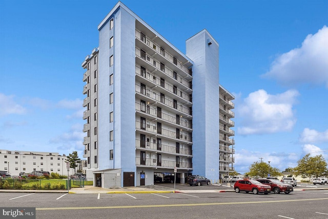 view of building exterior featuring uncovered parking
