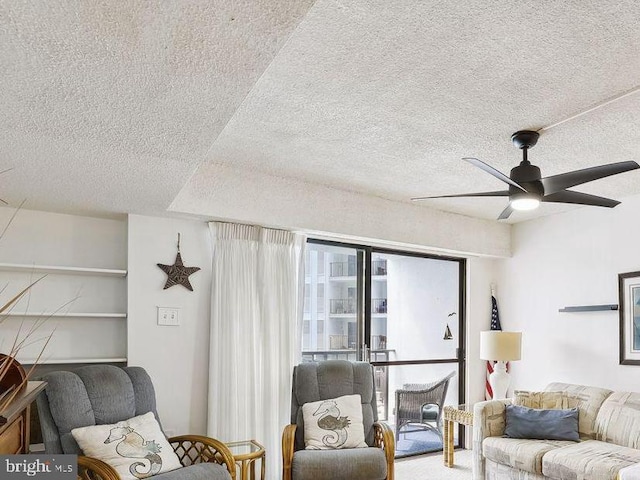 living room featuring a textured ceiling and ceiling fan
