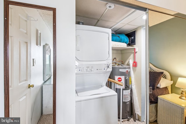 laundry room with carpet flooring, water heater, laundry area, and stacked washer and clothes dryer