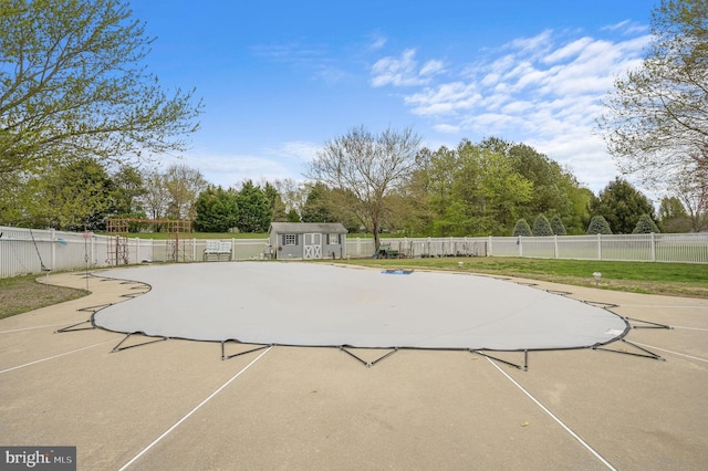 113 Fieldbrook, Magnolia, DE 19962 - view of pool featuring an outbuilding, a patio area, a storage shed, fence, and view of wooded area