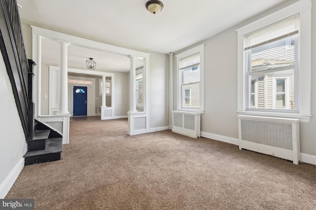 4011 Hayward Ave, Baltimore, MD 21215 - interior space with radiator heating unit, carpet flooring, baseboards, and decorative columns