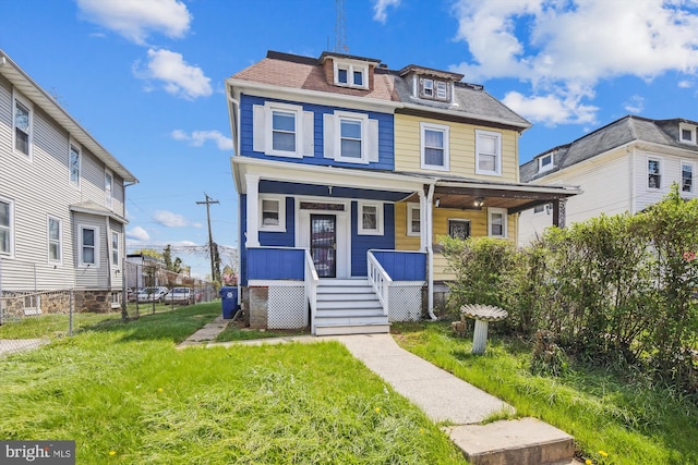4011 Hayward Ave, Baltimore, MD 21215 - traditional style home with a porch, fence, and a front lawn