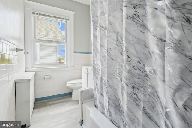 4011 Hayward Ave, Baltimore, MD 21215 - bathroom with toilet, vanity, tile walls, and a wainscoted wall
