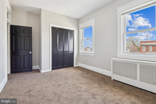 4011 Hayward Ave, Baltimore, MD 21215 - unfurnished bedroom with carpet flooring, a closet, baseboards, and radiator