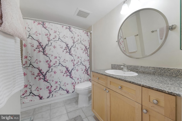 bathroom featuring visible vents, a shower with shower curtain, toilet, vanity, and tile patterned floors