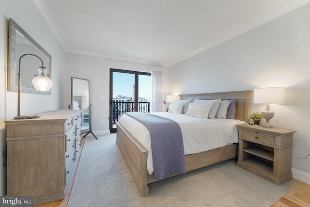 bedroom featuring crown molding, baseboards, and access to outside