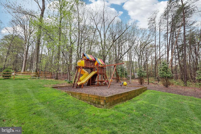 view of playground with a yard and fence