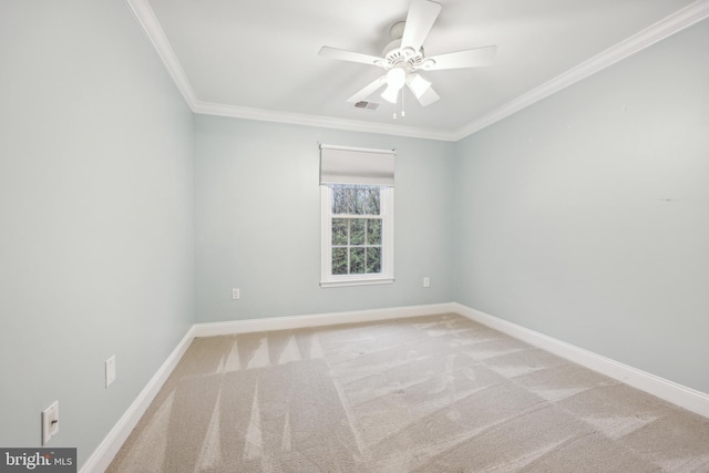carpeted empty room featuring ceiling fan, baseboards, ornamental molding, and visible vents