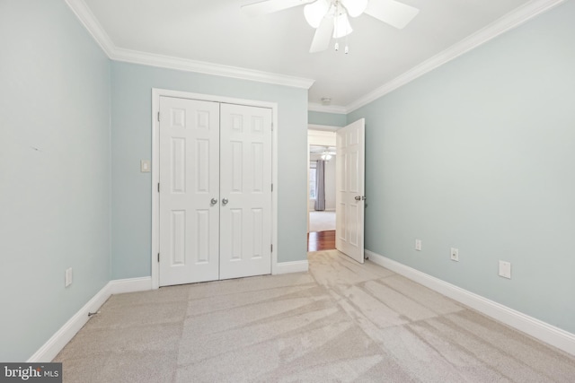 unfurnished bedroom with ornamental molding, carpet floors, baseboards, and a closet