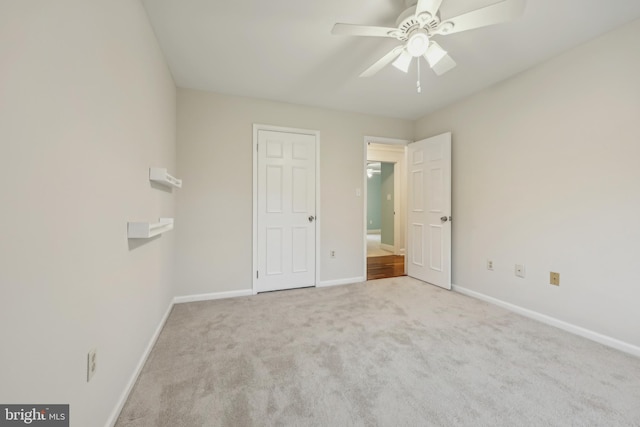 unfurnished bedroom featuring carpet flooring, baseboards, and a ceiling fan