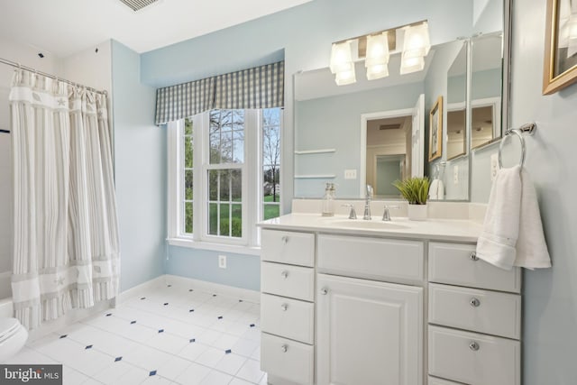 full bathroom featuring shower / tub combo, baseboards, toilet, vanity, and tile patterned floors