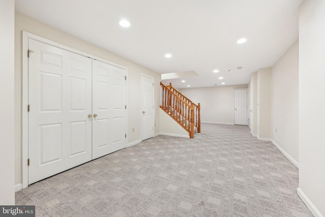 finished basement with recessed lighting, baseboards, carpet, and stairs