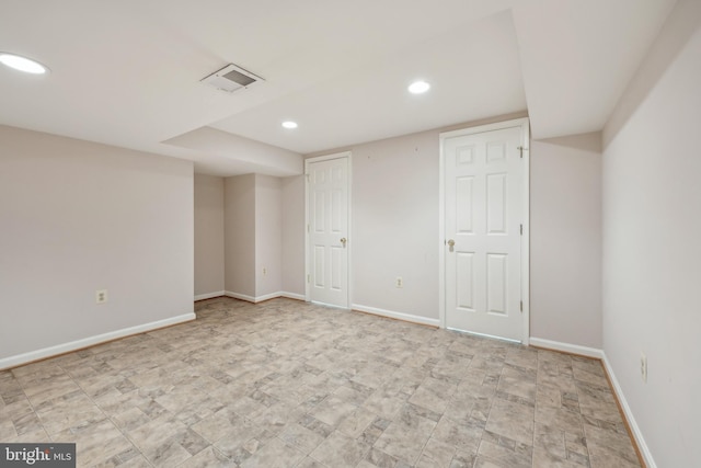 finished basement with baseboards, visible vents, and recessed lighting