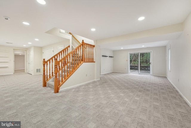 unfurnished living room with visible vents, recessed lighting, carpet, and stairway