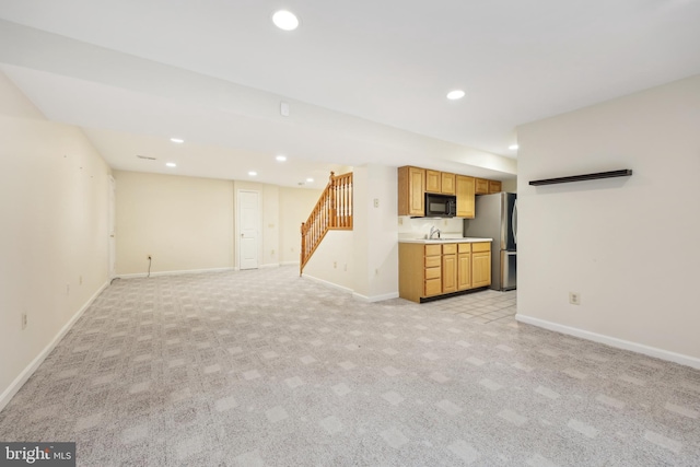 unfurnished living room with light carpet, recessed lighting, stairway, and baseboards