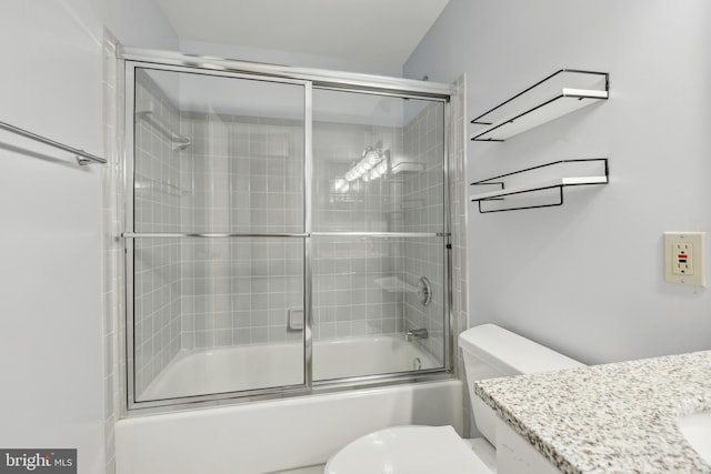 bathroom featuring bath / shower combo with glass door, vanity, and toilet