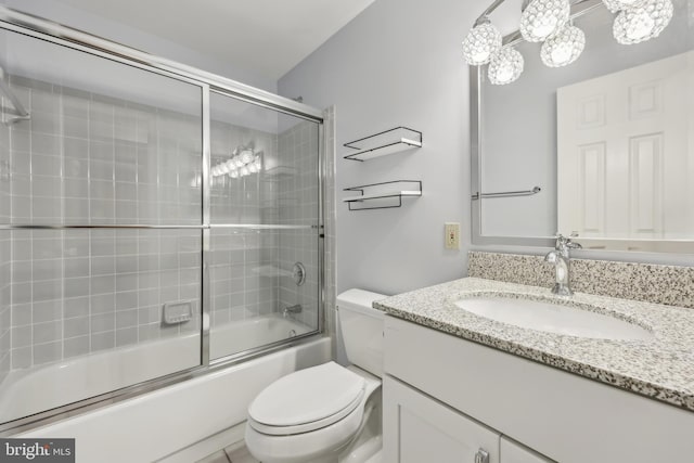 full bath featuring toilet, vanity, and enclosed tub / shower combo