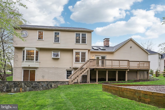 back of property featuring a chimney, stairway, a yard, a deck, and fence
