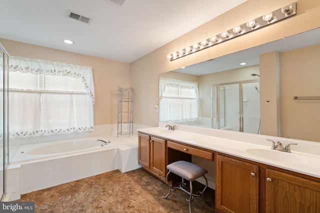 bathroom with double vanity, visible vents, a sink, a garden tub, and a stall shower