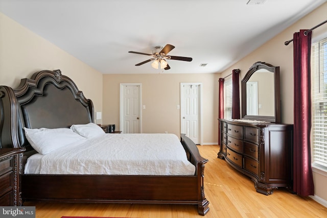 bedroom with visible vents, light wood-style floors, and multiple windows
