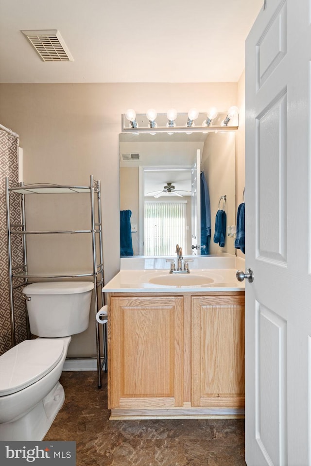 bathroom with toilet, a ceiling fan, vanity, and visible vents