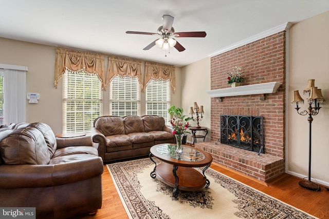 living room with a fireplace, wood finished floors, and a ceiling fan