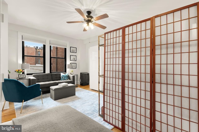 living area featuring ceiling fan and wood finished floors