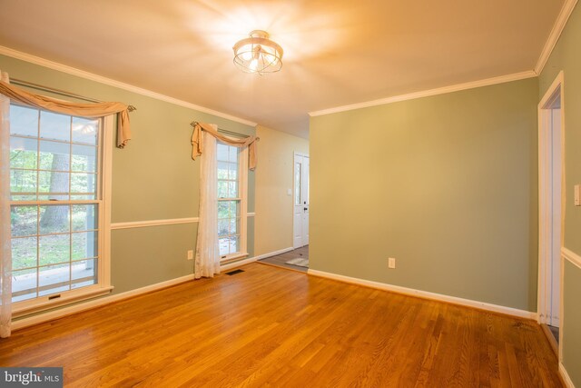 2409 Wood Stream Ct, Ellicott City, MD 21042 - spare room featuring wood finished floors, crown molding, and baseboards