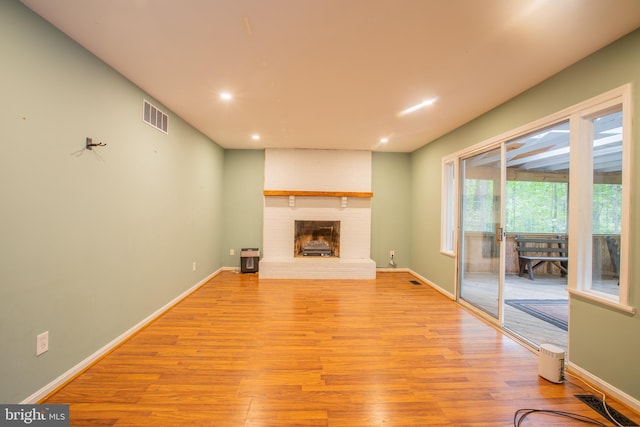 2409 Wood Stream Ct, Ellicott City, MD 21042 - unfurnished living room featuring light wood-style floors, recessed lighting, a brick fireplace, and baseboards