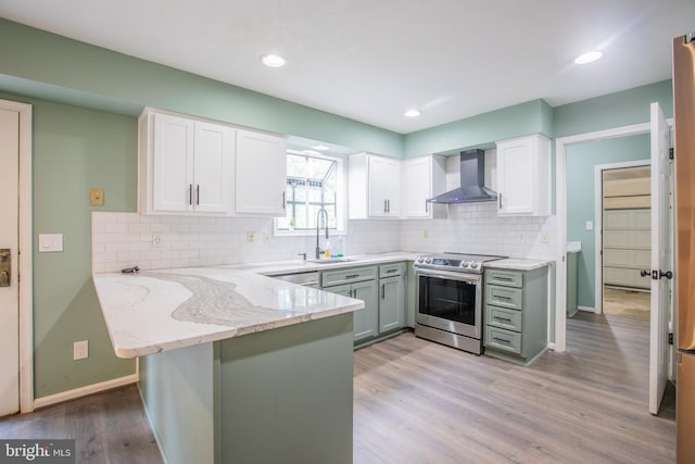 2409 Wood Stream Ct, Ellicott City, MD 21042 - kitchen with wall chimney exhaust hood, electric range, a peninsula, white cabinetry, and light stone counters