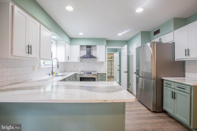 2409 Wood Stream Ct, Ellicott City, MD 21042 - kitchen featuring a sink, appliances with stainless steel finishes, wall chimney range hood, light stone countertops, and backsplash