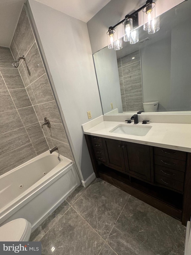 bathroom featuring vanity, toilet, a combined bath / shower with jetted tub, and tile patterned floors