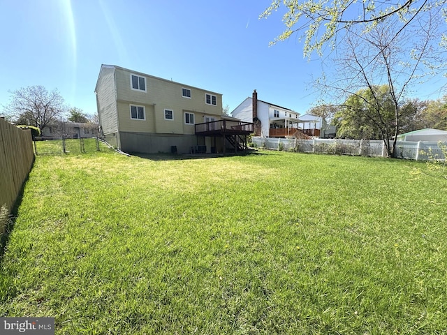 view of yard featuring a fenced backyard, a wooden deck, and stairway