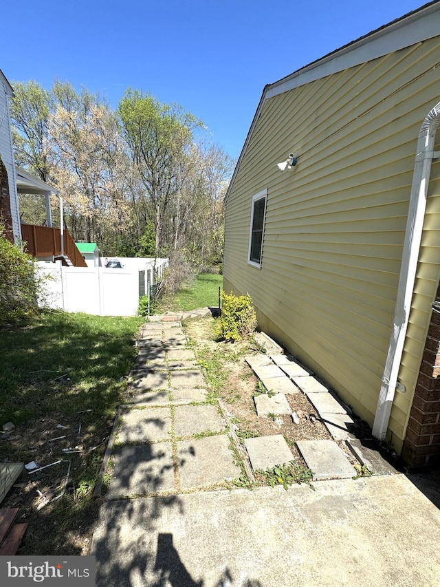 view of side of property featuring fence