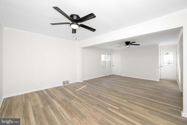unfurnished living room featuring visible vents, a healthy amount of sunlight, a ceiling fan, and light wood finished floors