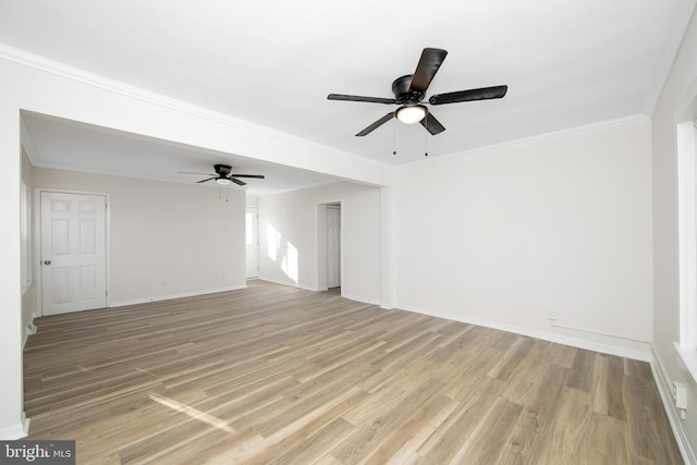 spare room with baseboards, crown molding, light wood-style flooring, and ceiling fan