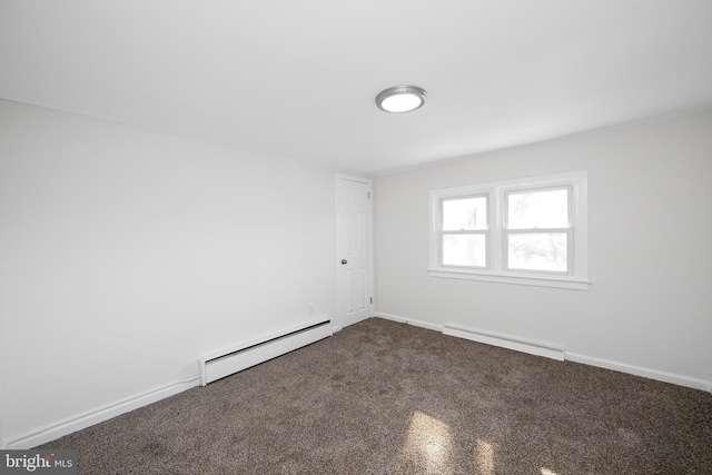 carpeted spare room featuring baseboards, a baseboard heating unit, and baseboard heating