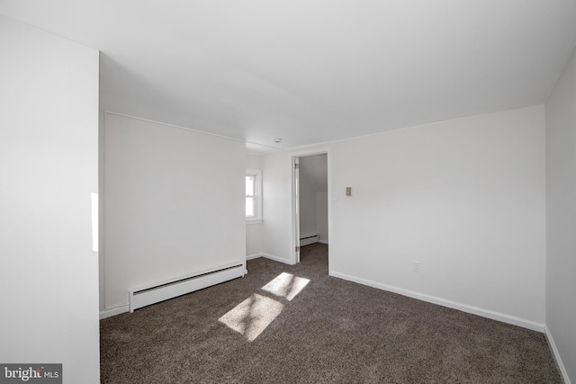 spare room featuring baseboards, carpet floors, and a baseboard radiator