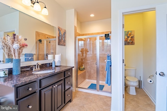 full bathroom featuring tile patterned flooring, toilet, vanity, and a stall shower