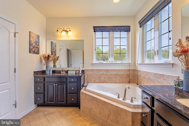 full bathroom featuring a bath, two vanities, tile patterned flooring, and a sink