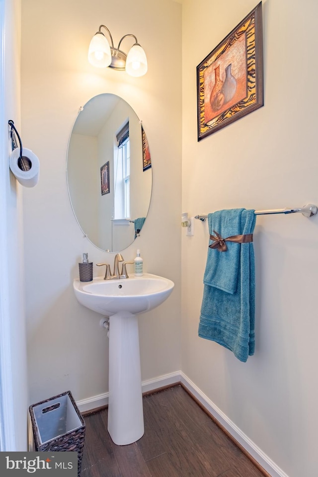 bathroom featuring baseboards and wood finished floors