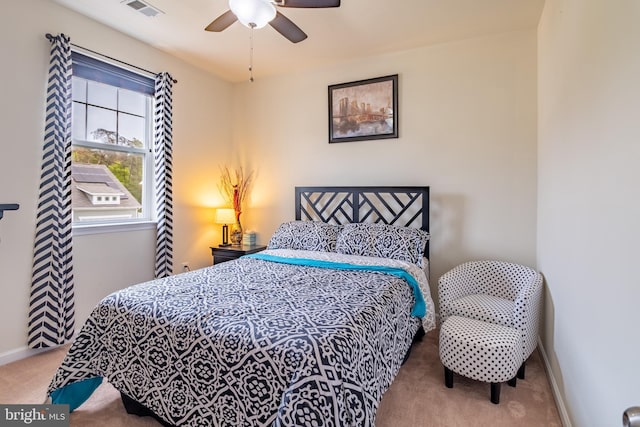 carpeted bedroom featuring visible vents, a ceiling fan, and baseboards