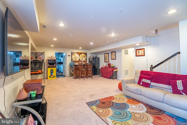 living room featuring recessed lighting, carpet floors, visible vents, and stairway