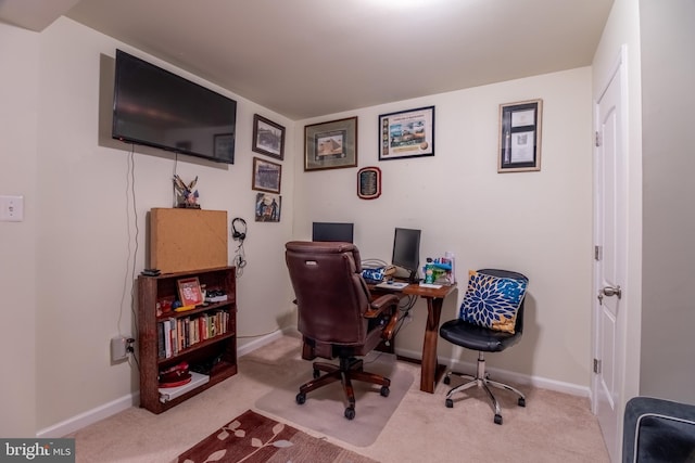 carpeted office space featuring baseboards