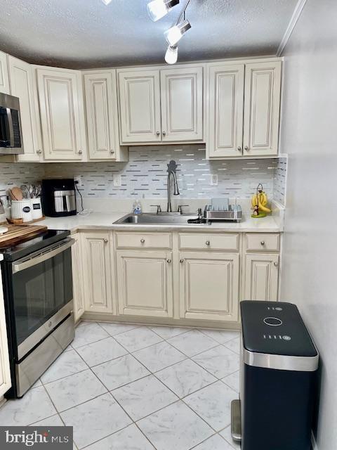 704 Pritchard Ln, Upper Marlboro, MD 20774 - kitchen featuring light countertops, a sink, stainless steel appliances, and decorative backsplash